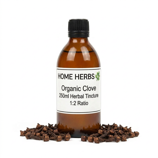 An amber glass bottle of Home Herbs Organic Clove Herbal Tincture 250ml, with a black cap and white label, surrounded by loose cloves on a white background.