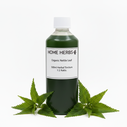A 500ml bottle of Home Herbs Organic Nettle Leaf herbal tincture, filled with dark green liquid and topped with a white cap, styled with fresh green nettle leaves on a clean white background.