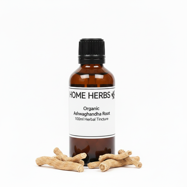 A 100ml amber glass bottle of Home Herbs Organic Ashwagandha Root herbal tincture, displayed on a white background with several raw root pieces arranged at its base.