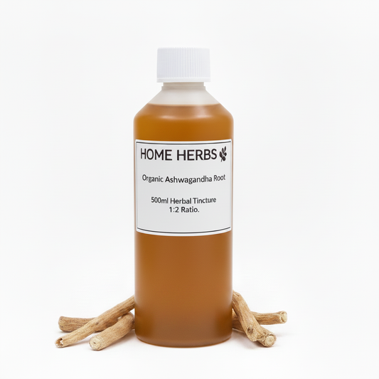 A 500ml bottle of Home Herbs Organic Ashwagandha Root herbal tincture, filled with an amber-brown liquid and topped with a white cap, displayed on a white background with dried ashwagandha roots arranged at its base.