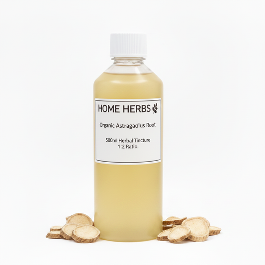 A clear plastic bottle filled with pale golden herbal tincture, topped with a white cap and labeled 'HOME HERBS Organic Astragalus Root 500ml Herbal Tincture 1:2 Ratio.' Small sliced roots are placed around the base on a clean white background.