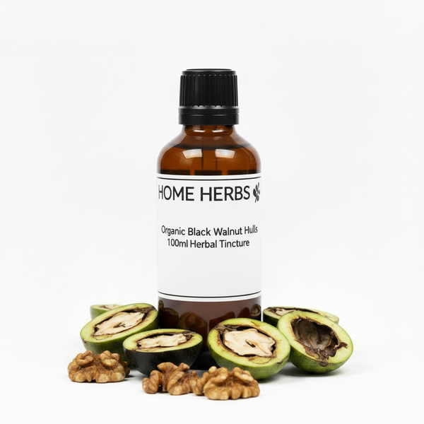 A 100ml amber glass bottle of Home Herbs Organic Black Walnut Hulled tincture, surrounded by fresh whole and halved black/green walnut hulls on a clean white background.