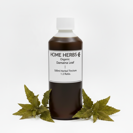 A 500ml bottle of Home Herbs Organic Damaina Leaf herbal tincture, displayed on a white background with green damaina leaves at its base.