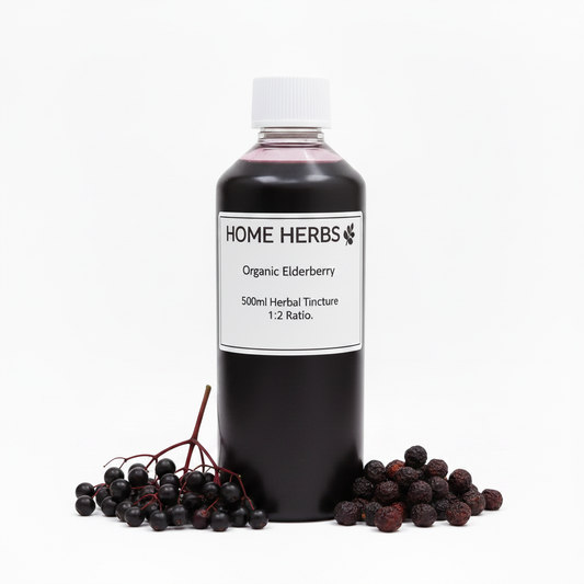 A 500ml bottle of Home Herbs Organic Elderberry Herbal Tincture, 1:2 ratio, displayed on a white background with fresh elderberry berries arranged at its base.