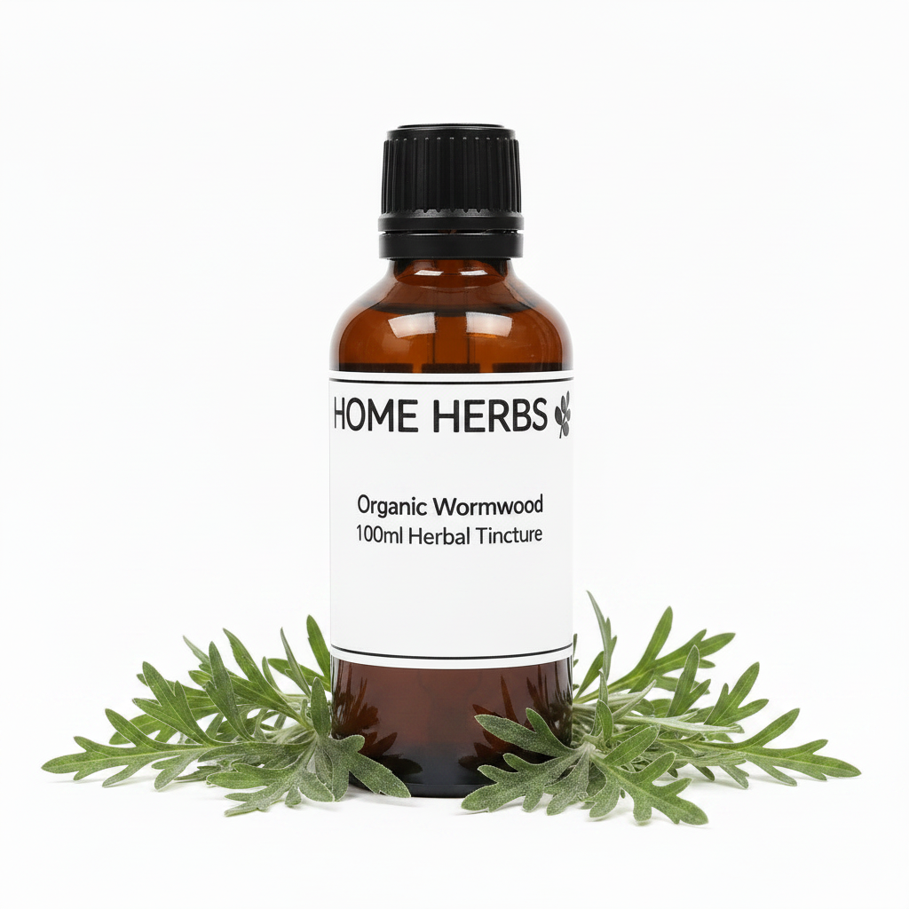 An amber glass bottle of Home Herbs Organic Wormwood 100ml Herbal Tincture with a white label and black cap, styled with fresh green wormwood leaves at the base on a white background.